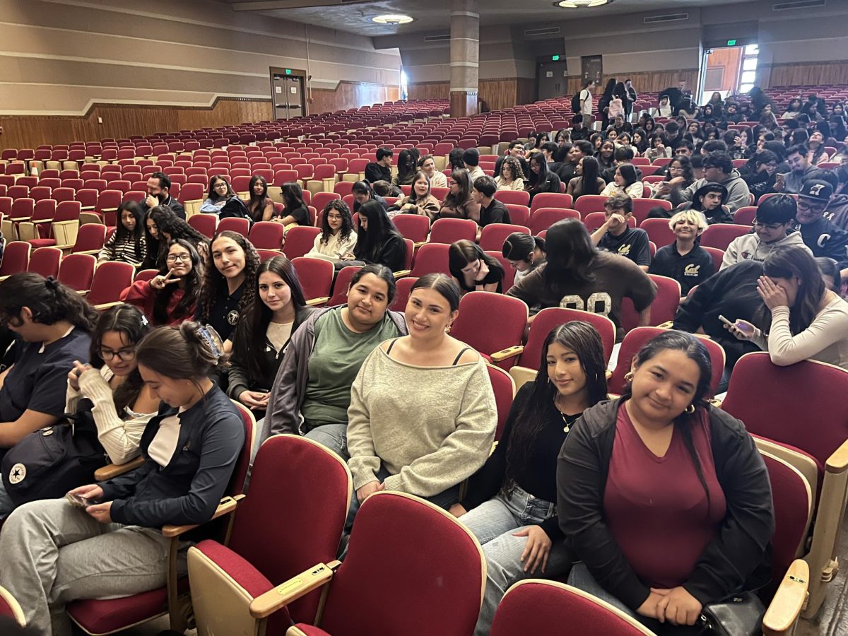 Seniors Yenesiah Garcia, Martha Gardeno, Kaitlyn Avaria, Genesis Garcia, Keira Karns Otero, and sophomores Edward Morales and Athena Lima wait for the Native American Presentation at Whittier High School to begin. The show featured traditional dancing and storytelling.  
