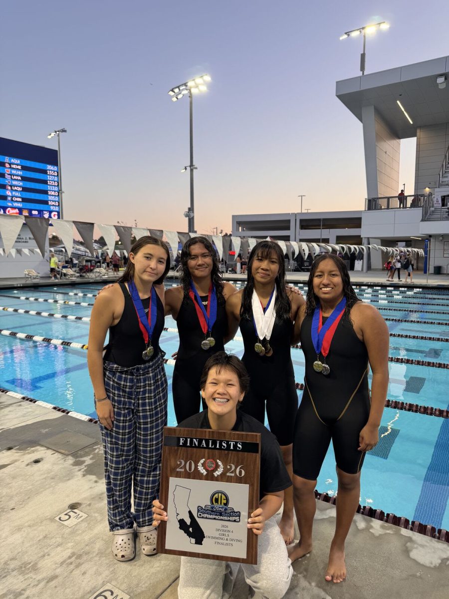 The girls' swim team poses for a picture after their meet: (left to right) Zoe Leal, Katherine Jimenez, Melinna Jimenez, Ellie Cruz and Emi Uesugi (bottom).